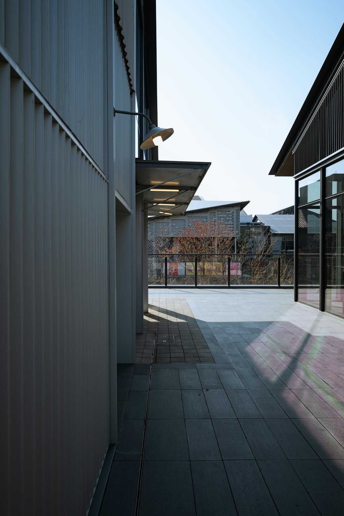An empty walkway between two buildings on a sunny day