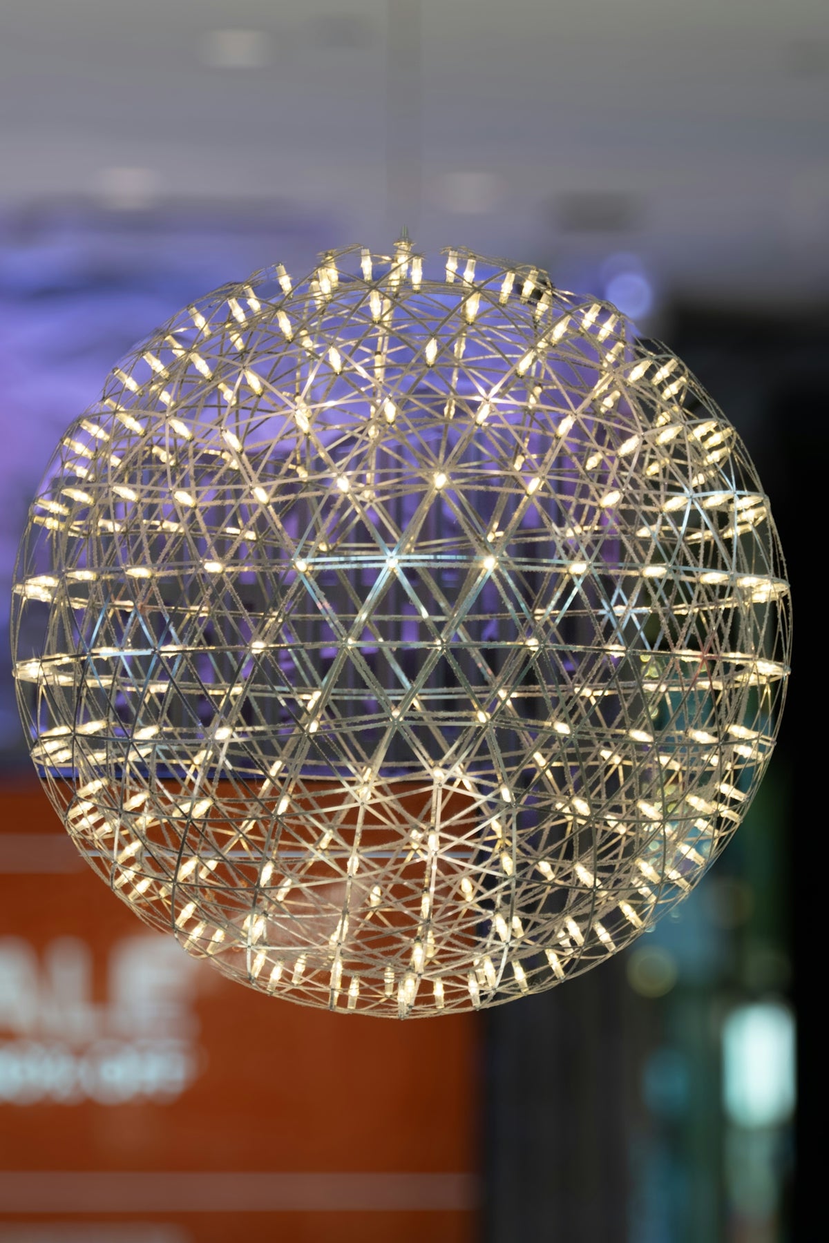 A ball of string lights hanging from a ceiling