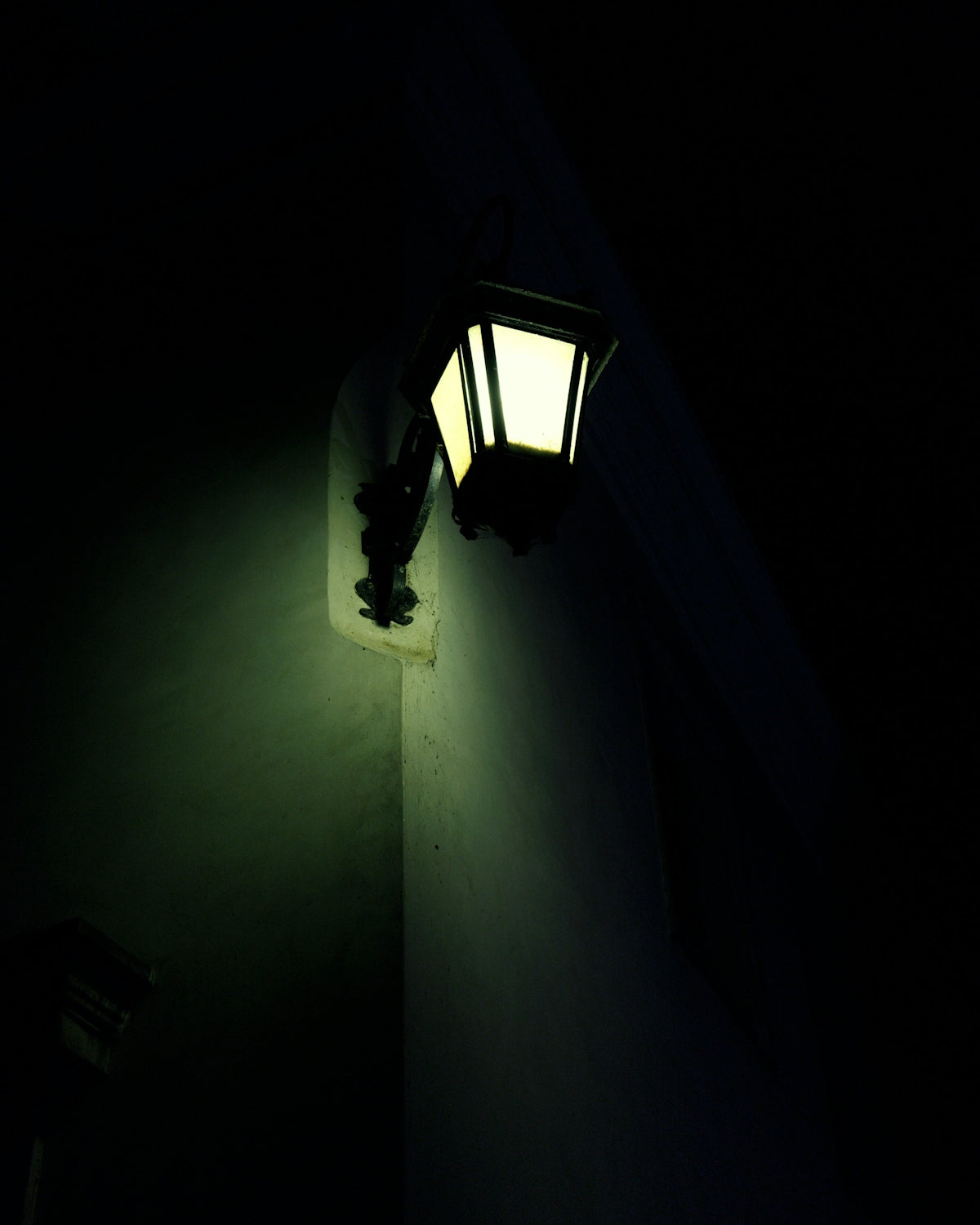A dark room with a light on the wall