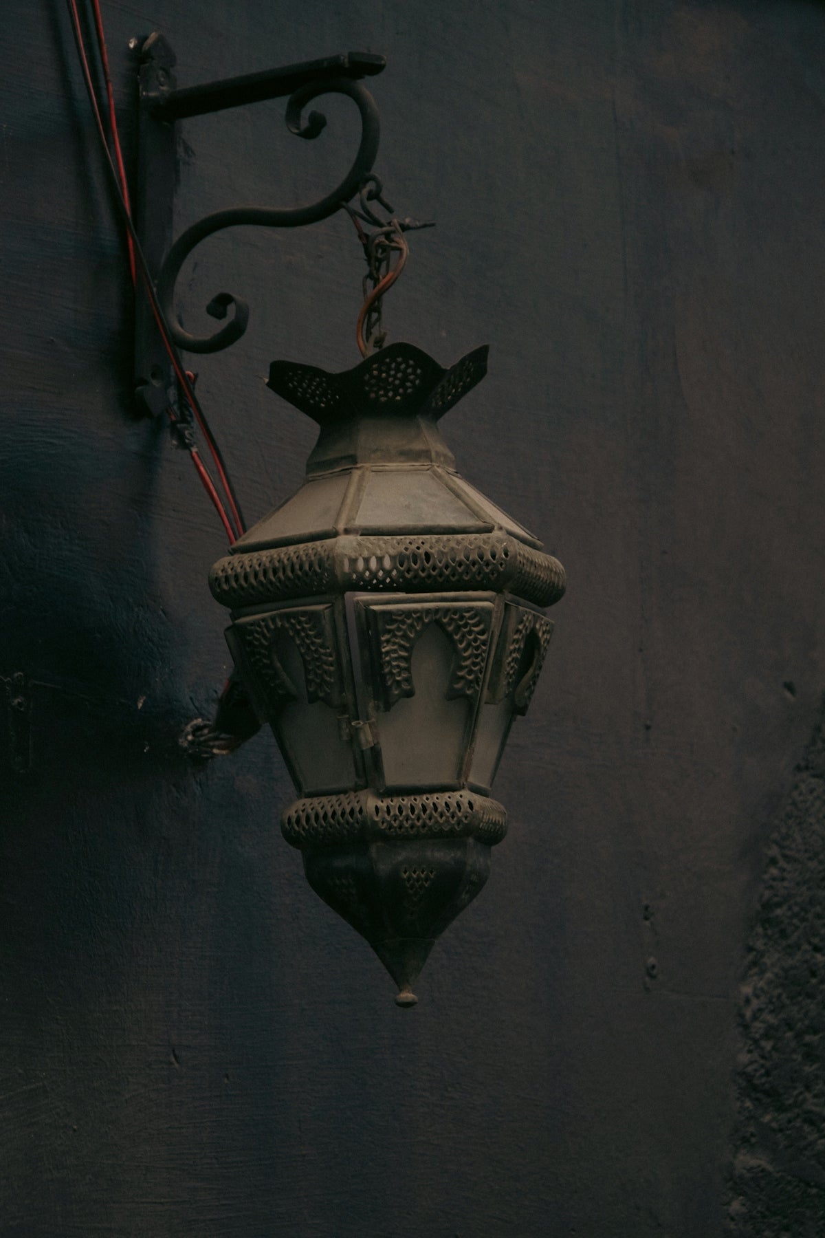 A lamp hanging from a wall in a dark room