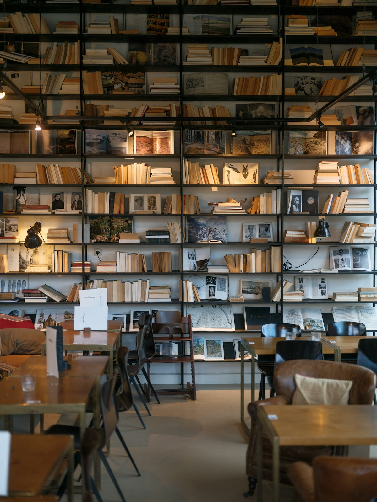 A library filled with lots of books next to a window
