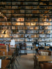 A library filled with lots of books next to a window