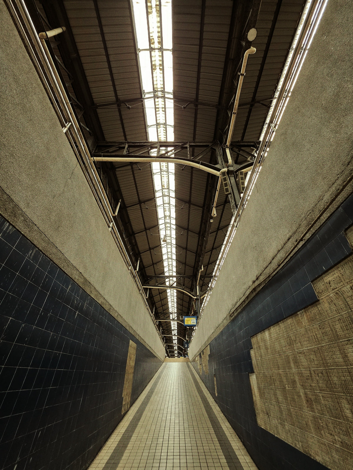 An empty train platform perspective stretches away.