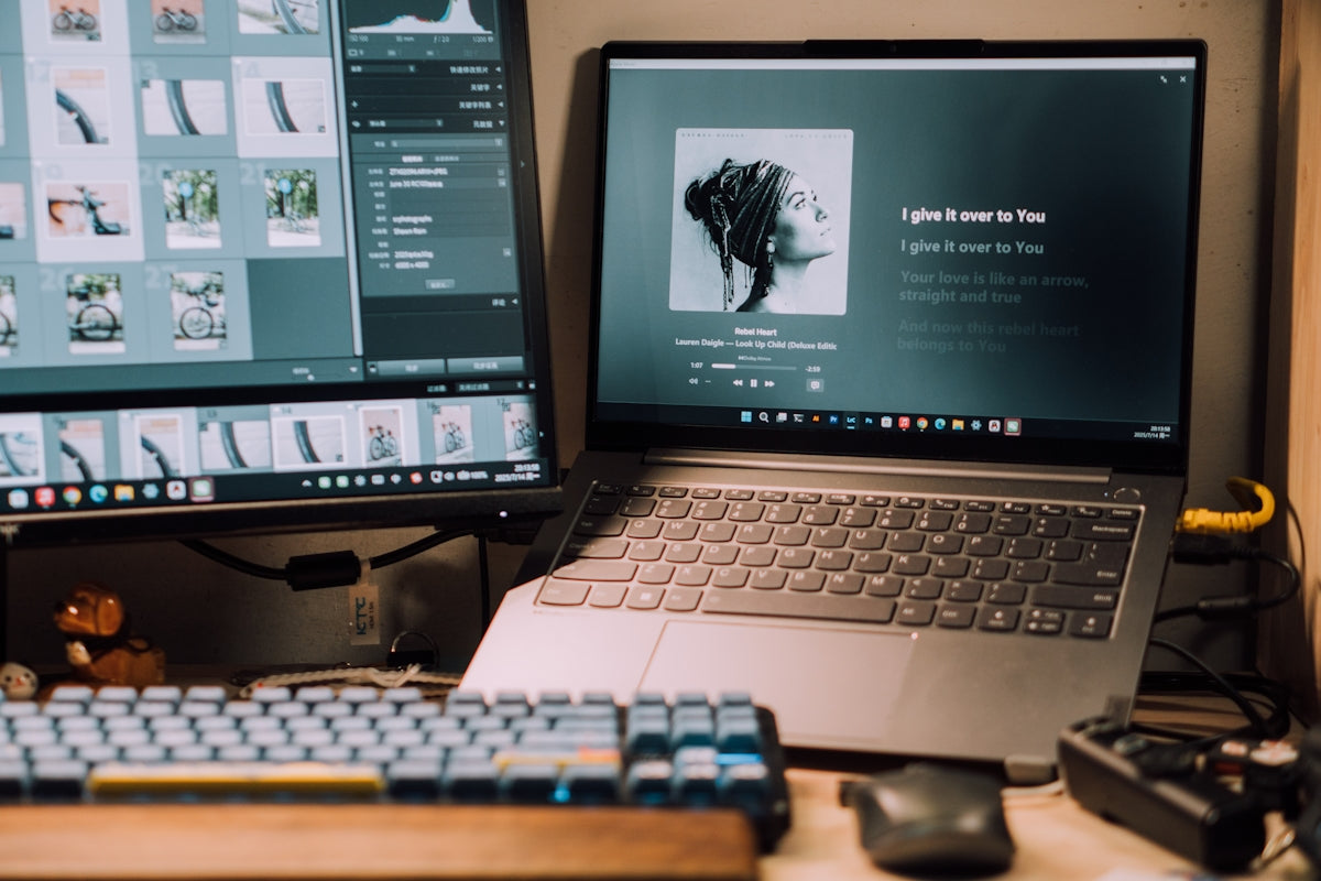 Laptop and monitor display music and programs.