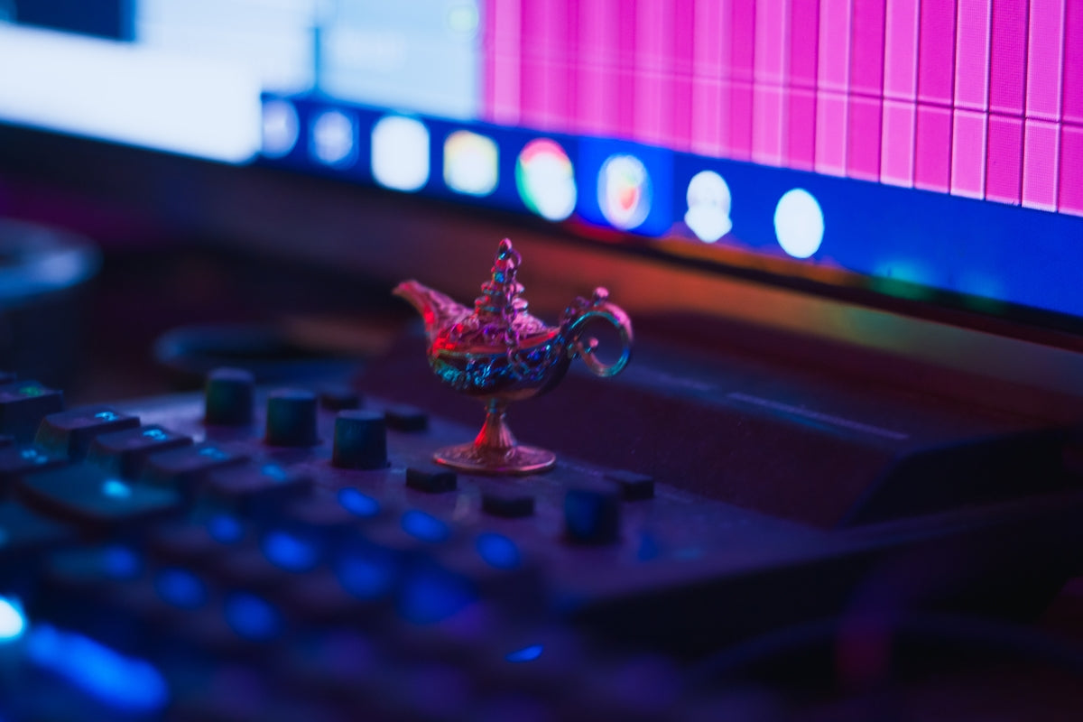 A miniature genie lamp sits on a keyboard.