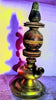 An antique brass and wood oil lamp with a shadow.