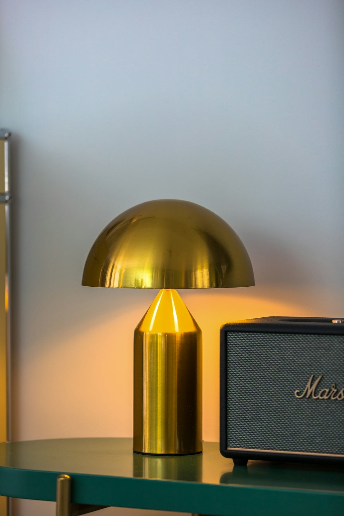 Golden mushroom lamp next to a marshall speaker