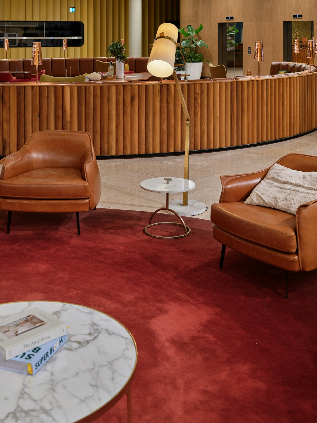 Two brown leather armchairs in a lounge area.