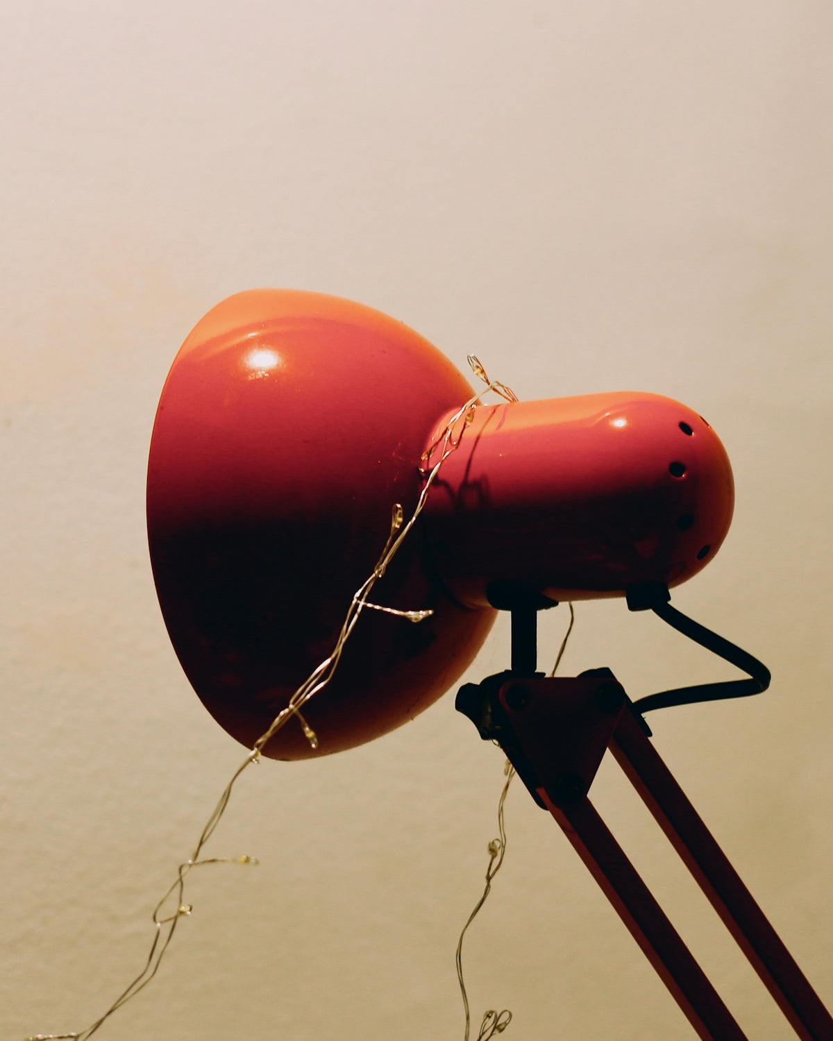 Red desk lamp with fairy lights wrapped around