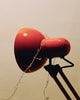 Red desk lamp with fairy lights wrapped around