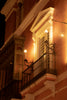 Ornate balcony with antique lamps at night