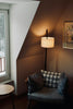 Cozy armchair with patterned cushion and lamp