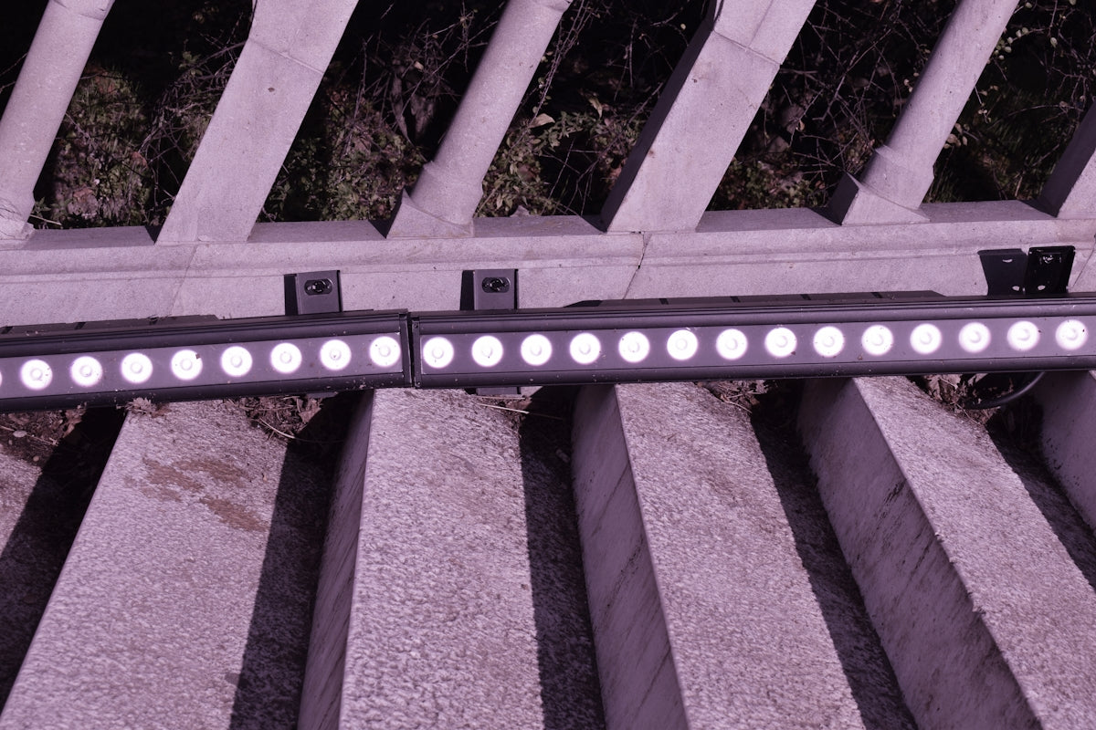Two linear led lights mounted on a railing.