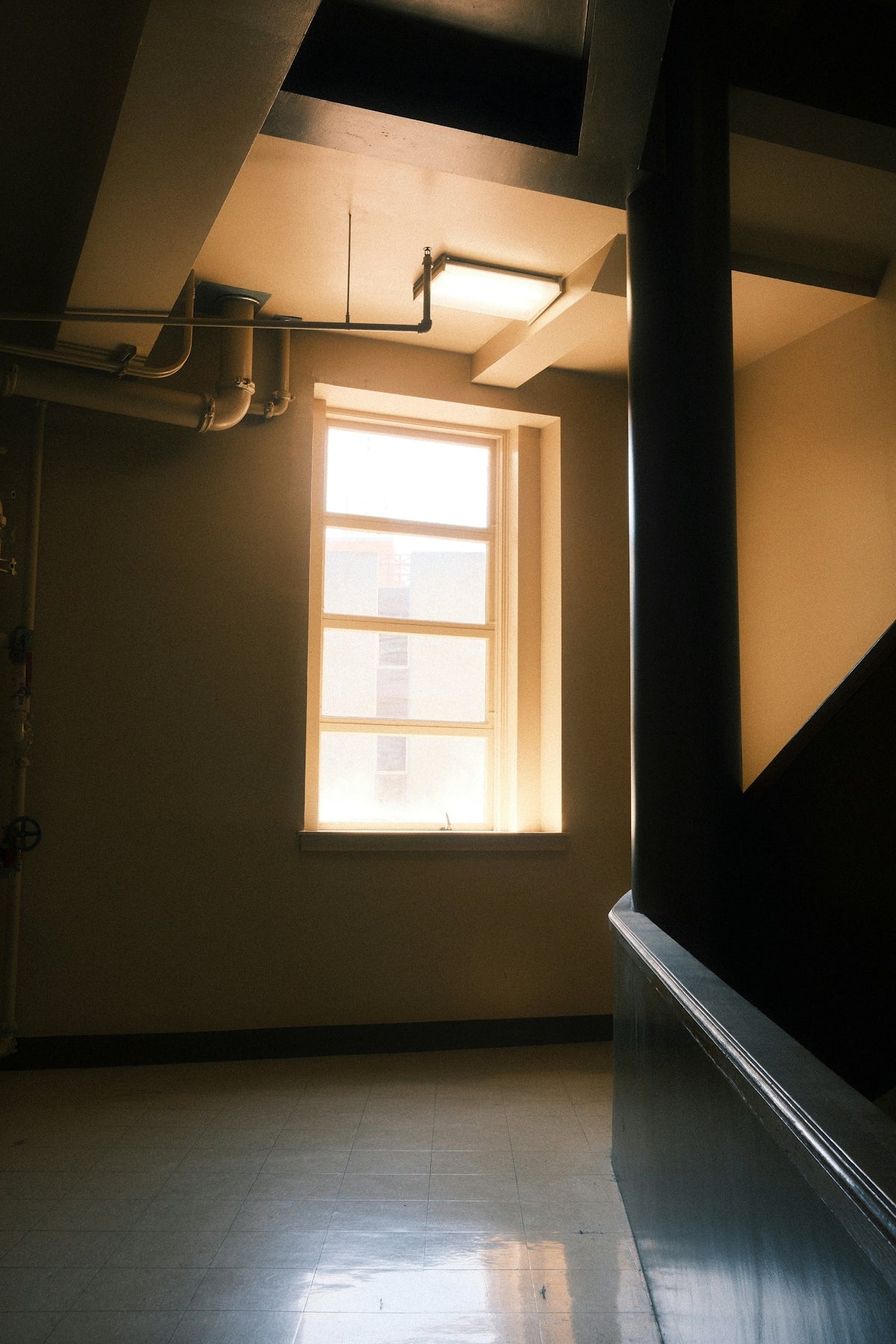 Stairwell with window and pipes