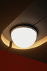 A modern ceiling light fixture with warm ambient lighting.