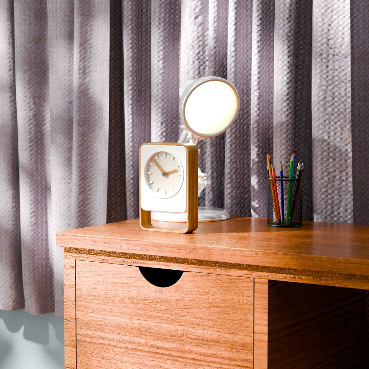 Desk with clock, lamp, and pens near pens