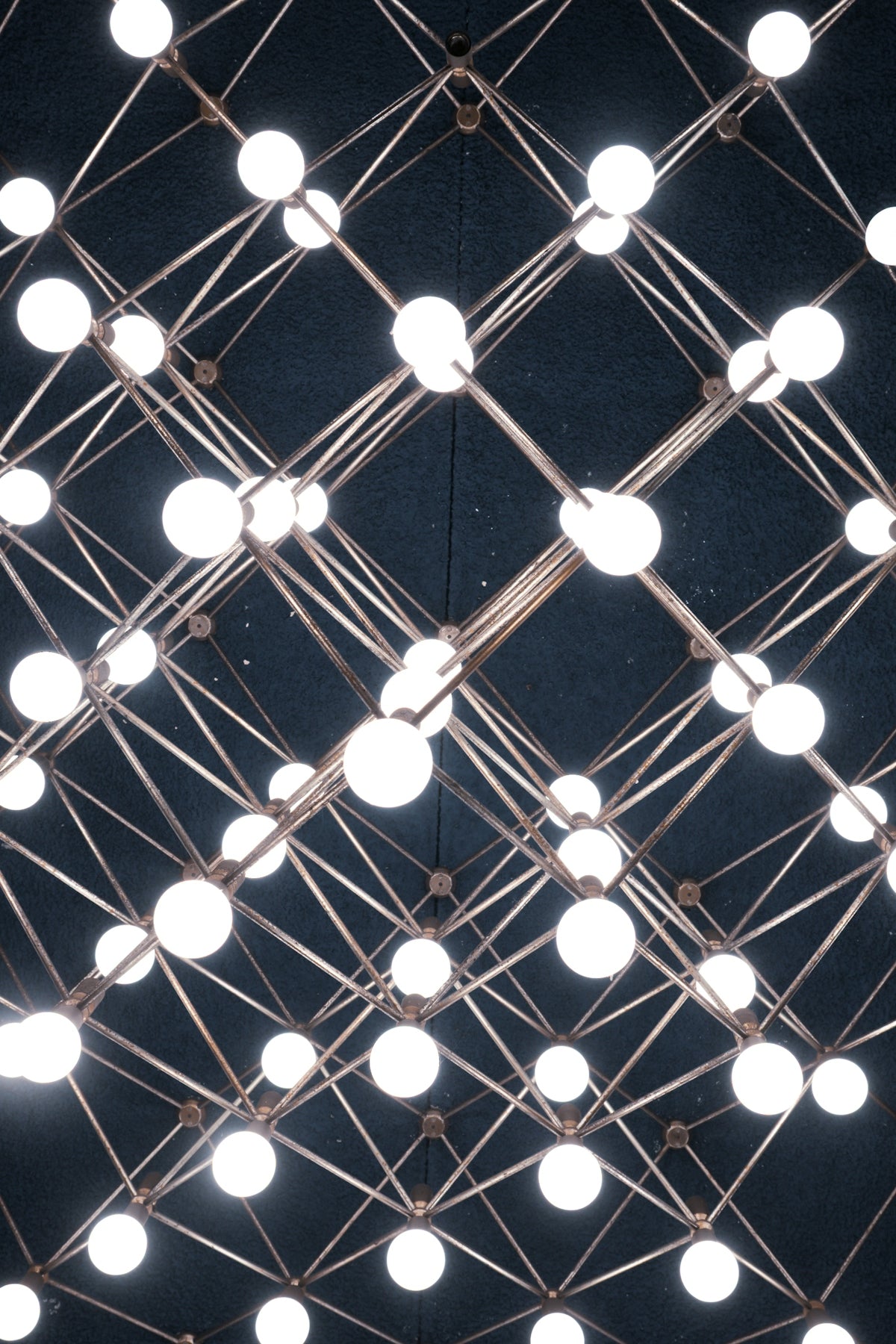 Geometric light fixture with many glowing bulbs