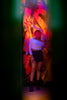 Woman posing in front of graffiti wall with colorful lights