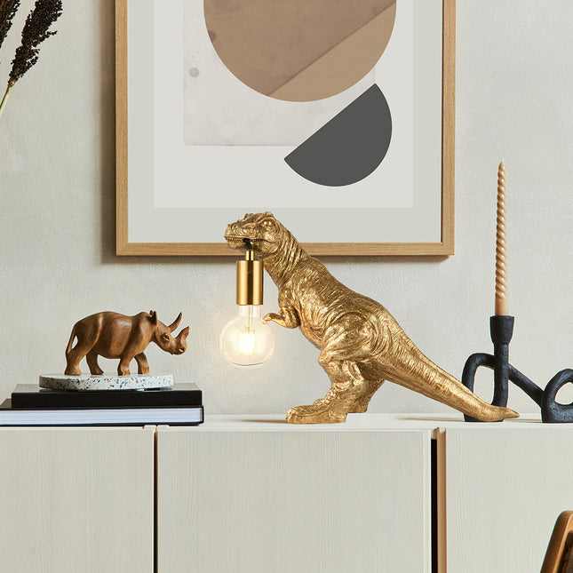 T-Rex Bite Table Lamp with Gold Finish and Unique Dinosaur Design.