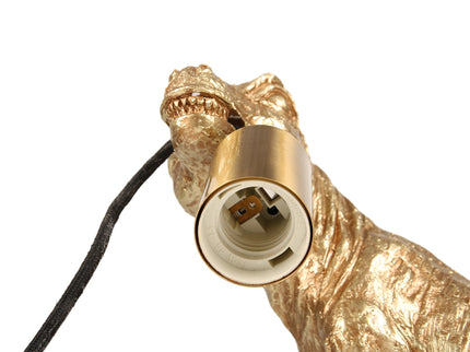 T-Rex Bite Table Lamp with Gold Finish and Unique Dinosaur Design.
